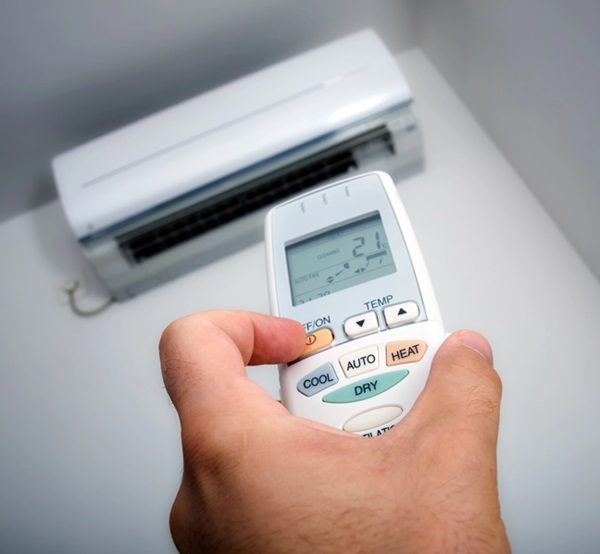 man with remote control air conditioning installation